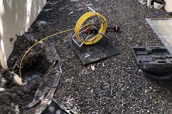 CCTV Camera Pipe Inspection in Sippy Downs with yellow roll of pipe being put down a pipe 