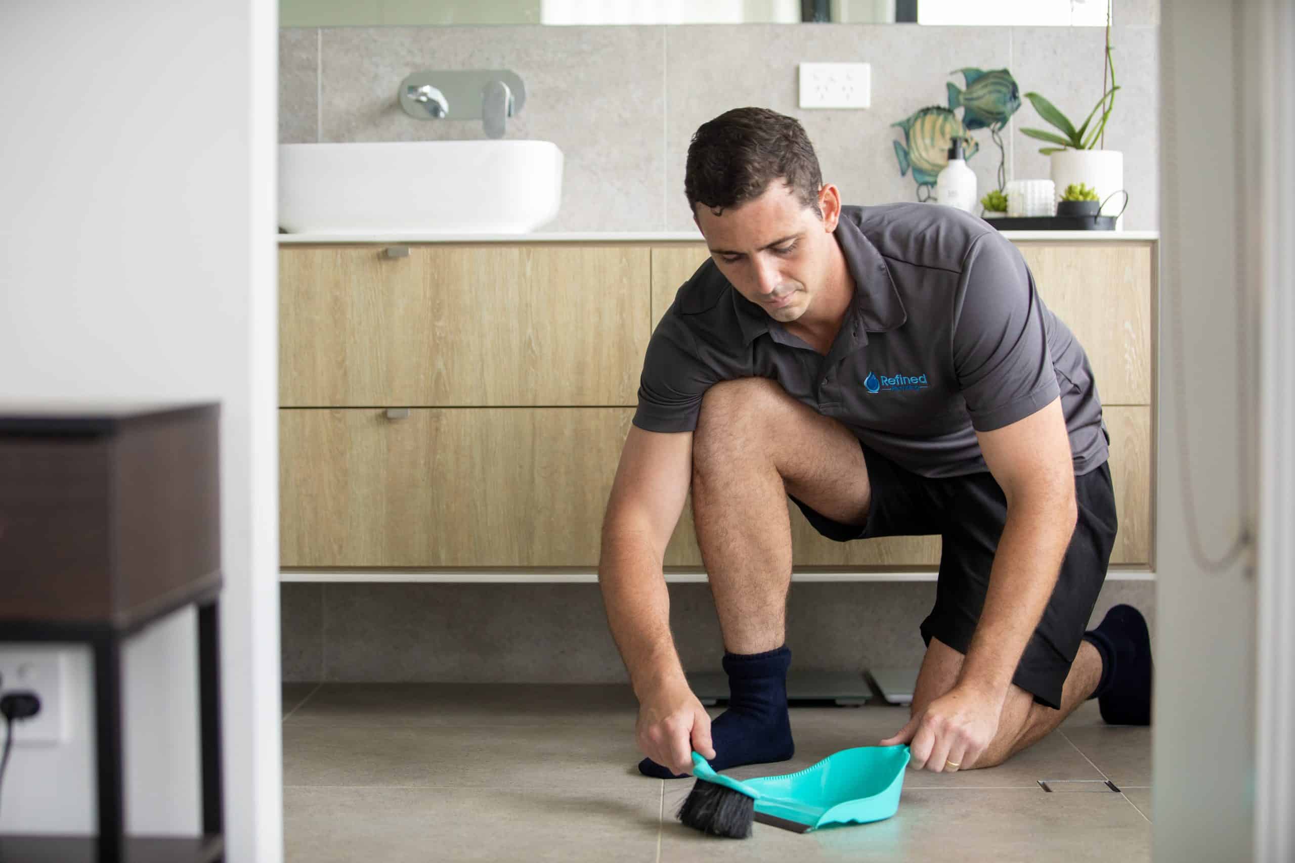 Refined Plumber tidying up as he works